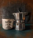 Moka pot and coffee cup dark background