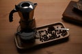 Moka pot coffee maker and coffee cup on wooden table. Royalty Free Stock Photo