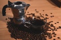 Moka pot and roasted coffee beans on wooden table. Royalty Free Stock Photo