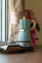 Moka Pot, Coffee pot for brewing coffee on a wooden table. Relax with a cup of coffee in the morning