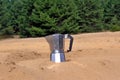 Moka pot in the desert sand Royalty Free Stock Photo