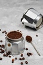 Moka pot filled with ground coffee, close-up, selective focus, gray minimalistic neutral background. Preparing Italian coffee in a Royalty Free Stock Photo