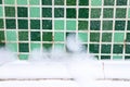 mold on joints between the ceramic tile in bathroom with a cleaning chemical foam. cleaning a black mildew dirt on the seams of mo Royalty Free Stock Photo