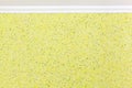 Molding and wall with yellow liquid wallpaper. Decorative, textured coating