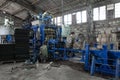 Moldova, Bender - June 28, 2019: Workers are repairing the conveyor for the production of paving slabs