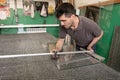 Moldova, Bender - May 18, 2019: A man of Eastern Europe measures and cuts glass for a pvc window