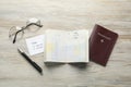 Moldova, Ceadir-Lunga - June 13, 2022: Passports with visa stamps, pen and glasses on wooden table, flat lay