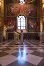 MOLDOVA - Curchi, August 18, 2018: woman in age praying at the icon in the Inside of the Curchi Monastery, Orhei