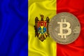 Moldova flag, bitcoin gold coin on flag background. The concept of blockchain, bitcoin, currency decentralization in the country.