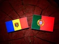 Moldovan flag with Portuguese flag on a tree stump isolated