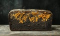 Moldy bread loaf with orange spores, dark crust, textured surface, rustic background Royalty Free Stock Photo