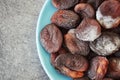 Moldy dried apricots on a plate.