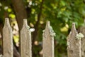 Moldy old wooden white picket fence in front of a green garden Royalty Free Stock Photo