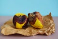 Moldy, quince with mold on a parchment paper, blue background Royalty Free Stock Photo