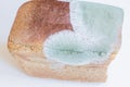 Moldy uneatable spoiled food. Mold on rye bread  on white background Royalty Free Stock Photo