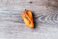 Moldy and wrinkled rotten peppers. Concept of unhealthy, decompose, spoiled vegetables. Garbage dump rotten food on wooden