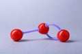 Molecular atom model on light grey background. Chemical structure