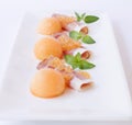 Molecular melon caviar, prosciutto and fresh melon Royalty Free Stock Photo