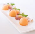 Molecular melon caviar, prosciutto and fresh melon Royalty Free Stock Photo