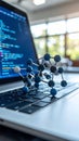 Molecular model on laptop keyboard with code in background, concept of research and technology Royalty Free Stock Photo