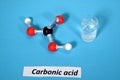 Molecule model of Carbonic Acid along with sample in a beaker. Royalty Free Stock Photo