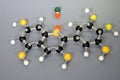 Molecule model of Paraffin. White is Hydrogen, black is Carbon, yellow is Oxygen and green is Chlorine. The orange spheres