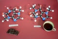 Molecule models of Theobromine, and Caffeine side by side. The arrow highlights the only difference. White is Hydrogen, black is Royalty Free Stock Photo