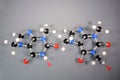 Molecule models of Theobromine left, and Caffeine right side by side. The red arrow highlights the only difference. White is