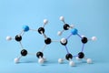 Molecule of nicotine on light blue background. Chemical model