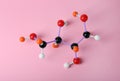 Molecule of sugar on pink background, top view. Chemical model