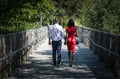 Molenbeek, Brussels Belgium : Mixed black and white couple walking on a pedestrian bridge in the park