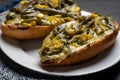 Molletes with poblano rajas and cheese on dark background. Mexican food