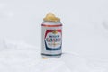 Molson Canadian Lager beer can in the snow, with frozen beer spuring out of it, put on a snow ground