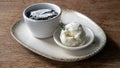 Molten chocolate lava cake and scopp of white ice cream served on a white plate