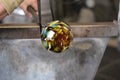 Molten glass on a metal rod for glass blowing macro