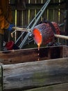 Molten hot bronze being poured out of the crucible.