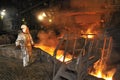 Molten hot steel pouring and worker Royalty Free Stock Photo