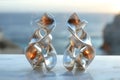 Molten metal style earrings, silver color and flowing shape.