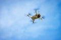 Ultralight Small White Drone Flying on Blue Sky with Clouds Royalty Free Stock Photo