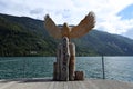 The wooden sculpture of an eagle on the pier of the Molveno lake.