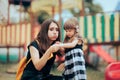 Mom Applying a Plaster on an Injured Daughter at the Playground