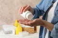 Mom applying talc powder from plastic tube Baby hygiene