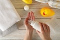 Mom applying talc powder from plastic tube. Baby