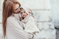 Mom and baby dressed in warm winter knitted clothing