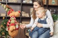 Mom with baby holding toy of big elk! Royalty Free Stock Photo