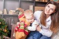 Mom with baby holding toy of big elk! Royalty Free Stock Photo