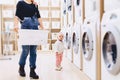 Mom and baby in the laundry take things and play Royalty Free Stock Photo