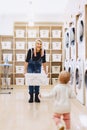 Mom and baby in the laundry take things and play Royalty Free Stock Photo