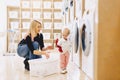 Mom and baby in the laundry take things and play Royalty Free Stock Photo