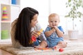 Mom and baby playing musical toys at home Royalty Free Stock Photo